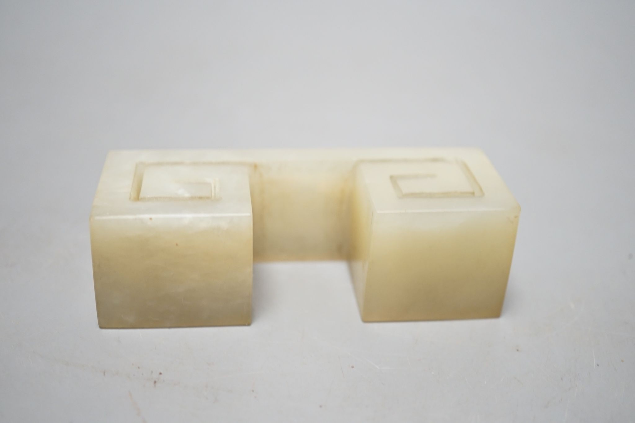 A Chinese pale celadon jade brush rest, 9.5 cms high.